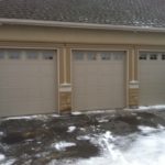 Three garage doors painted beige